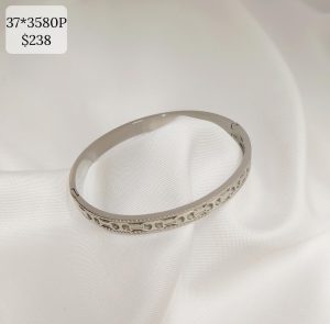 PULSO RIGIDO CENTRO ENGRANES OVALO LATERALES BRILLOS